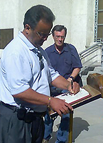 man signing guest book
