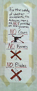 image of tent city safety sign that reads: no guns, no blades, no knives