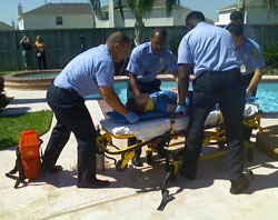 Fire fighters evacuate a mock drowning victim