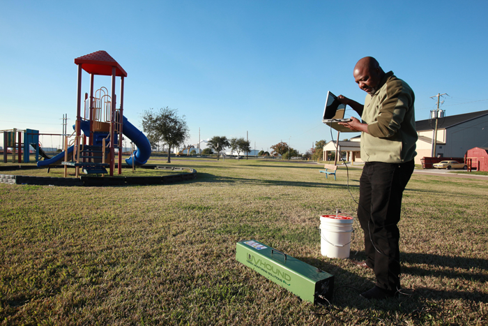 Hilton Kelley testing contamination levels near a playground