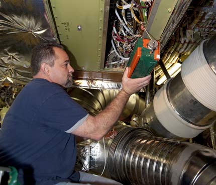 a technician inside space shuttle Endeavour