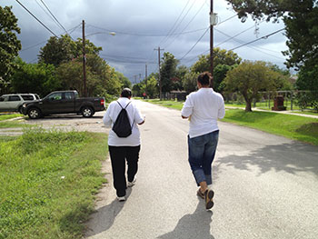Houston health department workers Rosalind Augustine, left, and Sharisa Daniel walking 