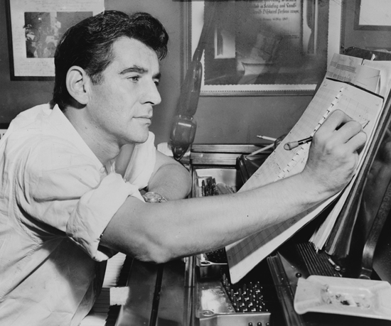 Leonard Bernstein composing at the piano in 1955.