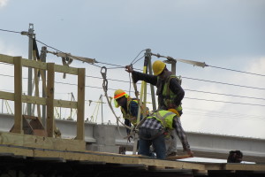 Photo of a crew working atop one of the new connector ramps