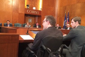 Toby Cole (left) addresses a city council committee
