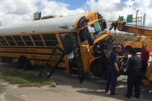 the school bus as it is being towed away from the scene