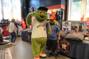 Astros mascot "Orbit" poses for pictures with fans at the team shop at Minute Maid Park.