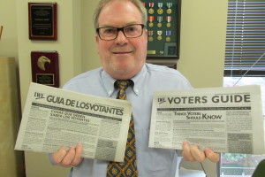 Tom Berg holds up LWV's voters guide