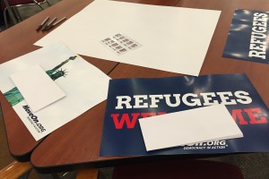 Envelopes and posters sit on a table on campus.