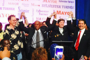 Sylvester Turner holds up hands in victory