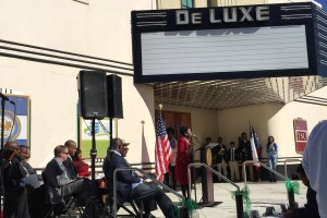 Congresswoman Sheila Jackson Lee stands at a podium speaking to a crowd gathered to celebrate the grand opening.