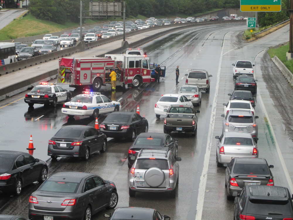 Houston Police clear an accident on rain-slick I-45.