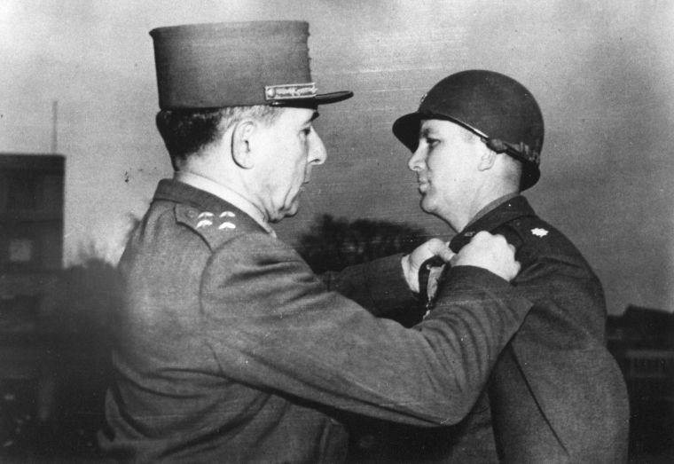 A French officer decorates Lt. Col. James Earl Rudder with a medal for valor