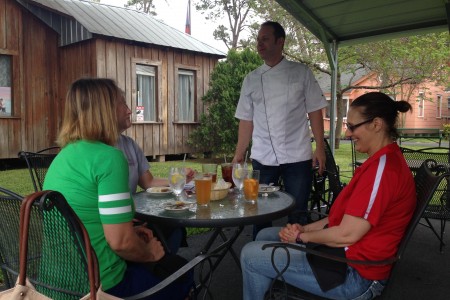 Joe Macri, owner of The Italian Joint and The Black Sheep Bistro along with his wife Maria Gagis, talk with customers as they have lunch in The Black Sheep Bistro’s patio.