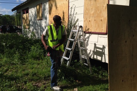 Harris County employee Ronald Thomas works on boarding up an abandoned home in the Acres Homes area, which was the first property targeted as part of the clean-up program.