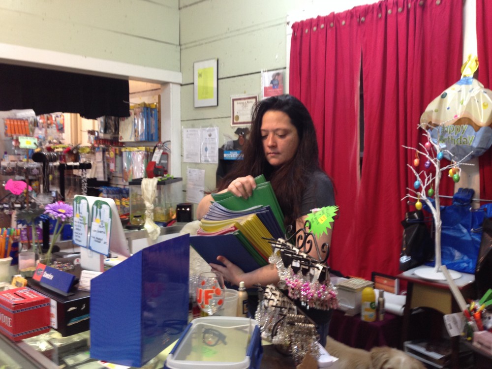 Sandra Van Fleet, owner of The Teacher Creature, arranges merchandise at her store, which specializes in office and school supplies.