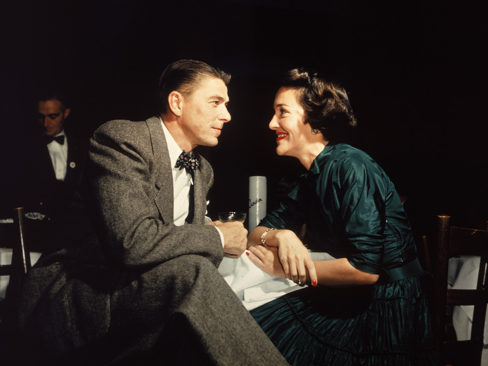 Actor Ronald Reagan and his wife, Nancy, gaze at one another across a table in 1952.