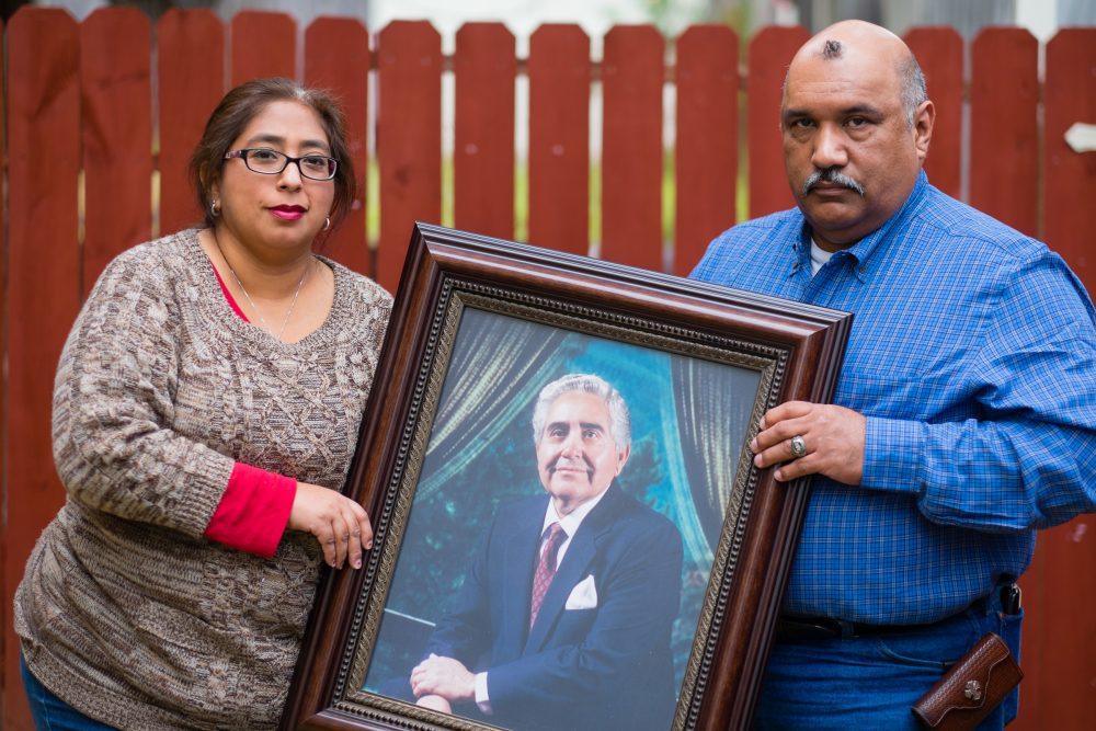Patty Rodriguez and her brother, Alex, hold a photo of their late father Demetrio Rodriguez Sunday, March 1, 2015 in San Antonio.