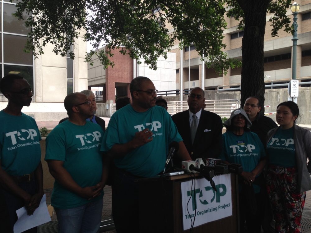 Texas Organizing Project member Feldon Bonner (center) speaks at a press conference held in front of the Harris County Criminal Court building. The activist organization advocates for changes in the county's bail system.