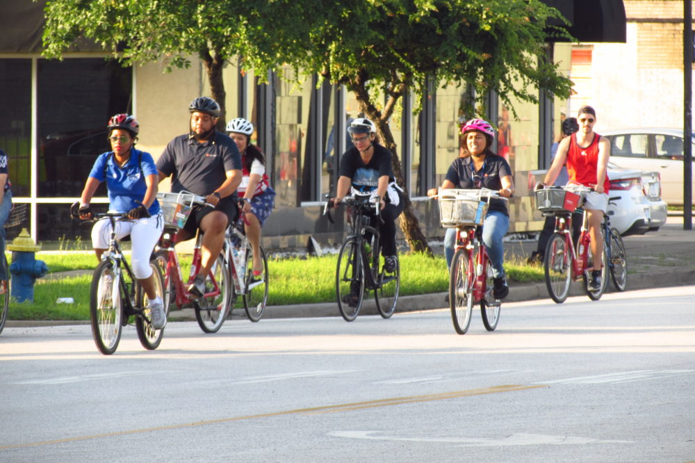 Cyclists enjoy a group ride on Houston Avenue. 