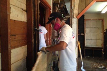 A volunteer working with the group Operation Blessing helps clean up a Rosenberg home located close to the Brazos River that got flooded.