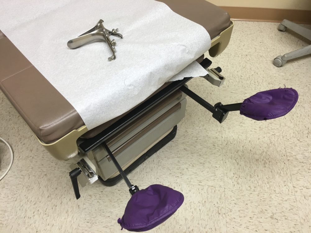 A speculum and gynecological exam table.