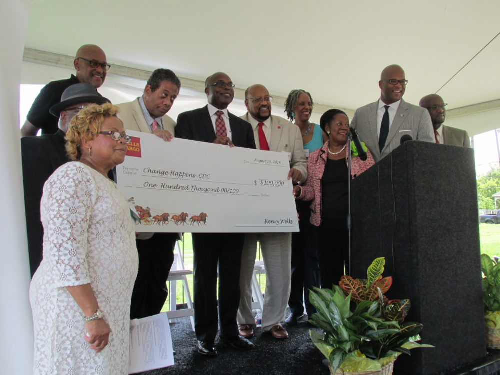 Darryl Montgomery, regional president of Wells Fargo, center, hands a symbolic check for $100,000 to members of the Northern Third Ward Consortium. Also pictured are U.S. Rep. Sheila Jackson Lee, D-Houston, and Houston City Council member Dwight Boykins (both on the right)