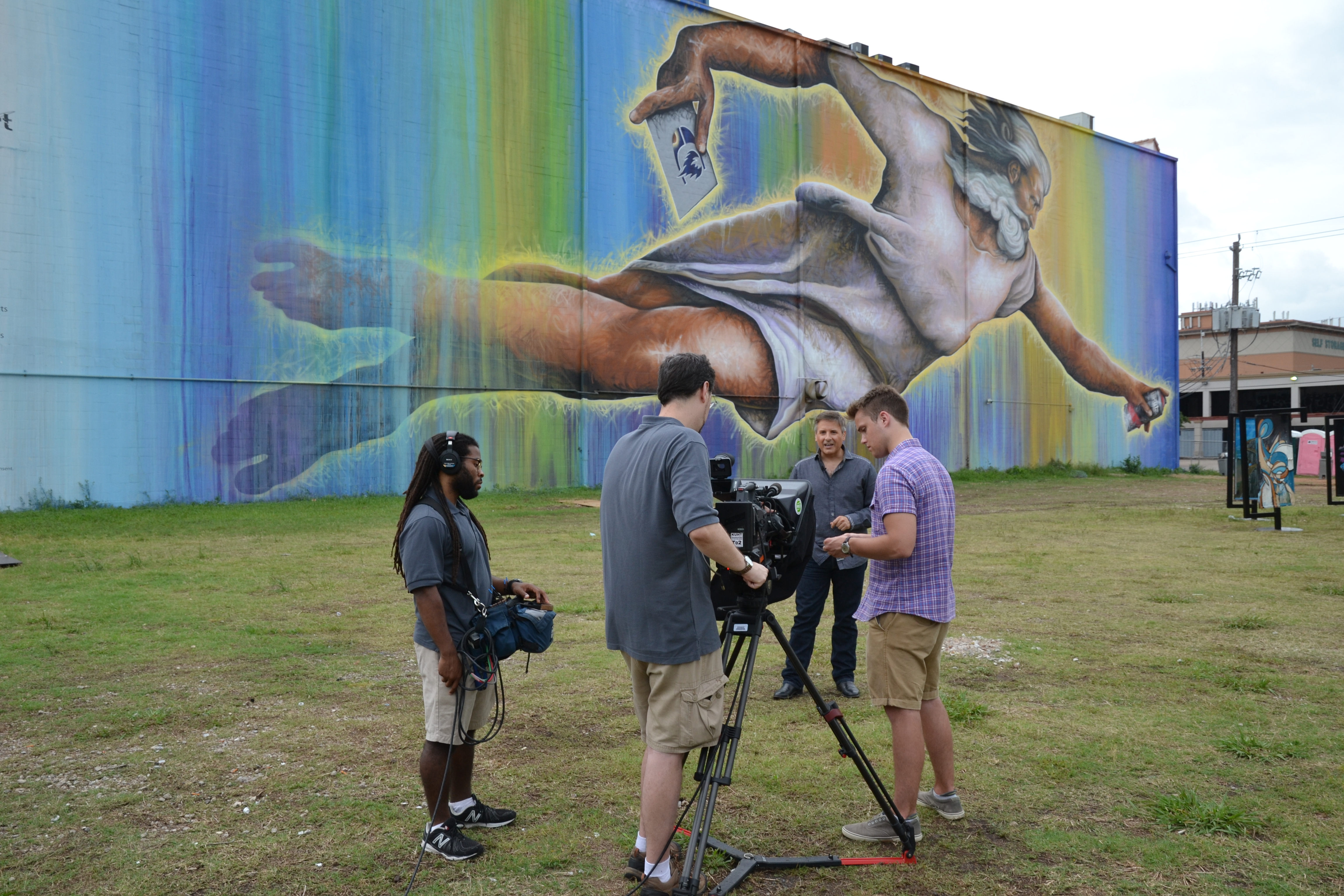 Houston Public Media's Brandon Alexander, Matt Brawley, Ernie Manouse and Cameron Knott shoot and episode of Arts InSight at the site of Houston's biggest mural, by artist Sebastien "Mr. D" Boileau.