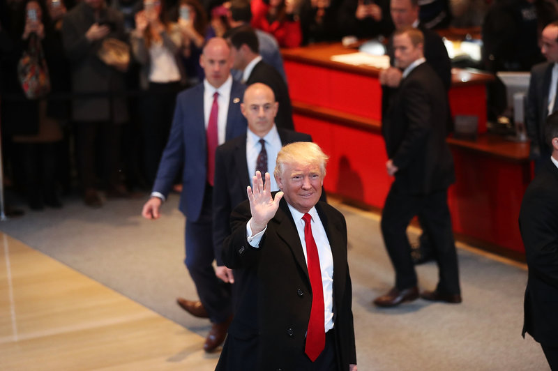 President-elect Donald Trump walks through the lobby of the New York Times following a meeting with editors at the paper on Tuesday in New York City.