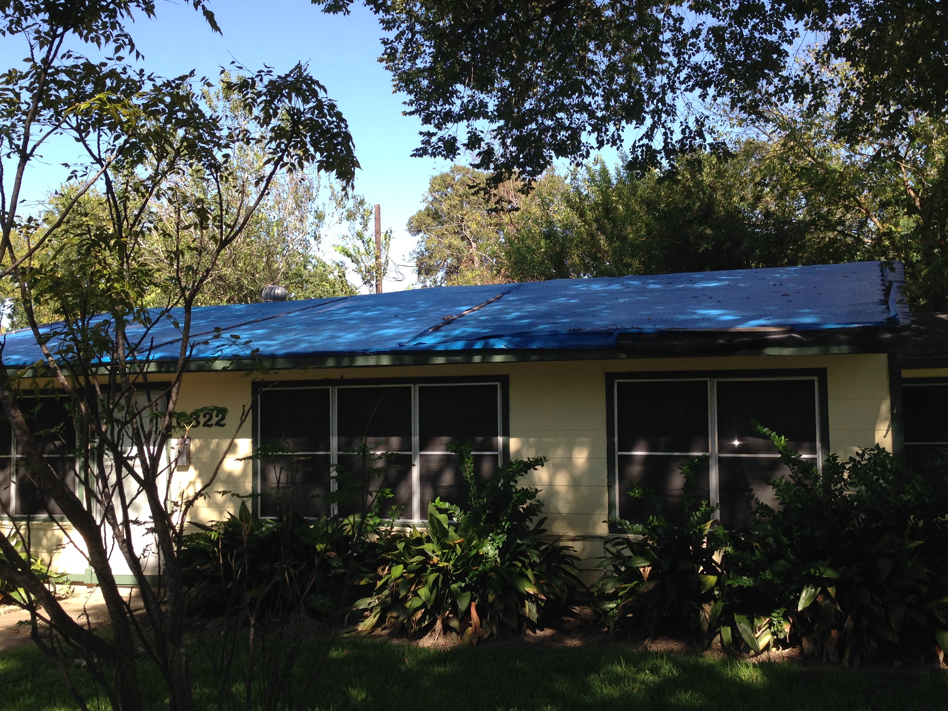 Tarps such as the one this photo shows covered the roof of Ms. Huff's home for eight years.