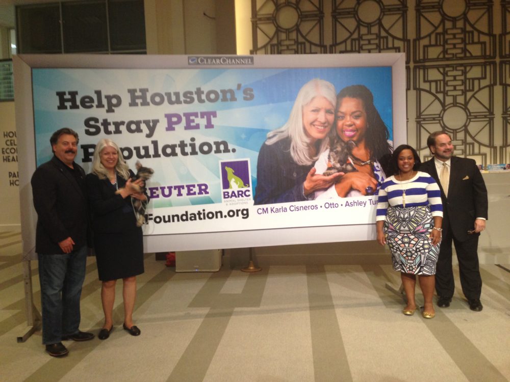 Alan Ratliff, chair and president of Houston BARC Foundation, Council Member Karla Cisneros –who is holding Otto— Ashley Turner, Mayor Sylvester Turner's daughter and Lee Vela, vice president of Public Affairs of Clear Channel Outdoor pose next to the campaign's billboard.