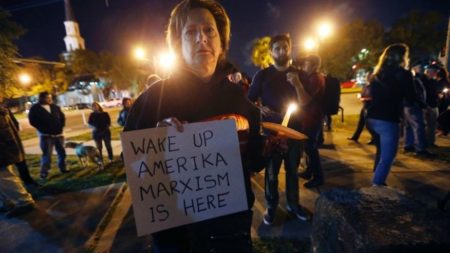 Dana Farley, of New Orleans, participates in a candlelight vigil at the statue of Jefferson Davis in New Orleans, Monday, April 24, 2017. New Orleans will begin taking down Confederate statutes, becoming the latest Southern body to divorce itself from what some say are symbols of racism and intolerance. (AP Photo/Gerald Herbert)