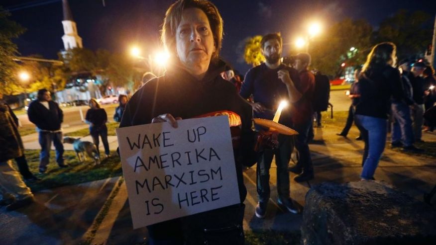 Dana Farley, of New Orleans, participates in a candlelight vigil at the statue of Jefferson Davis in New Orleans, Monday, April 24, 2017. New Orleans will begin taking down Confederate statutes, becoming the latest Southern body to divorce itself from what some say are symbols of racism and intolerance. (AP Photo/Gerald Herbert)