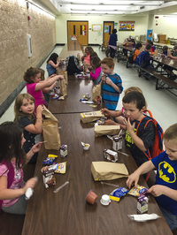 The kids in the after-school program get a healthy snack before they go to classes and other activities.