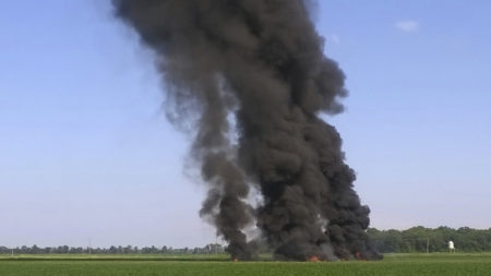 Smoke and flames rise where a military transport plane crashed near Itta Bena, Miss., on Monday, killing at least 16.