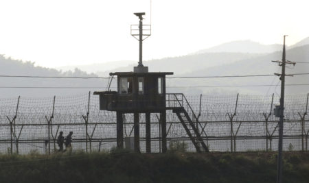 South Korean army soldiers patrol on Monday along the barbed-wire fence in Paju, near the border with North Korea.