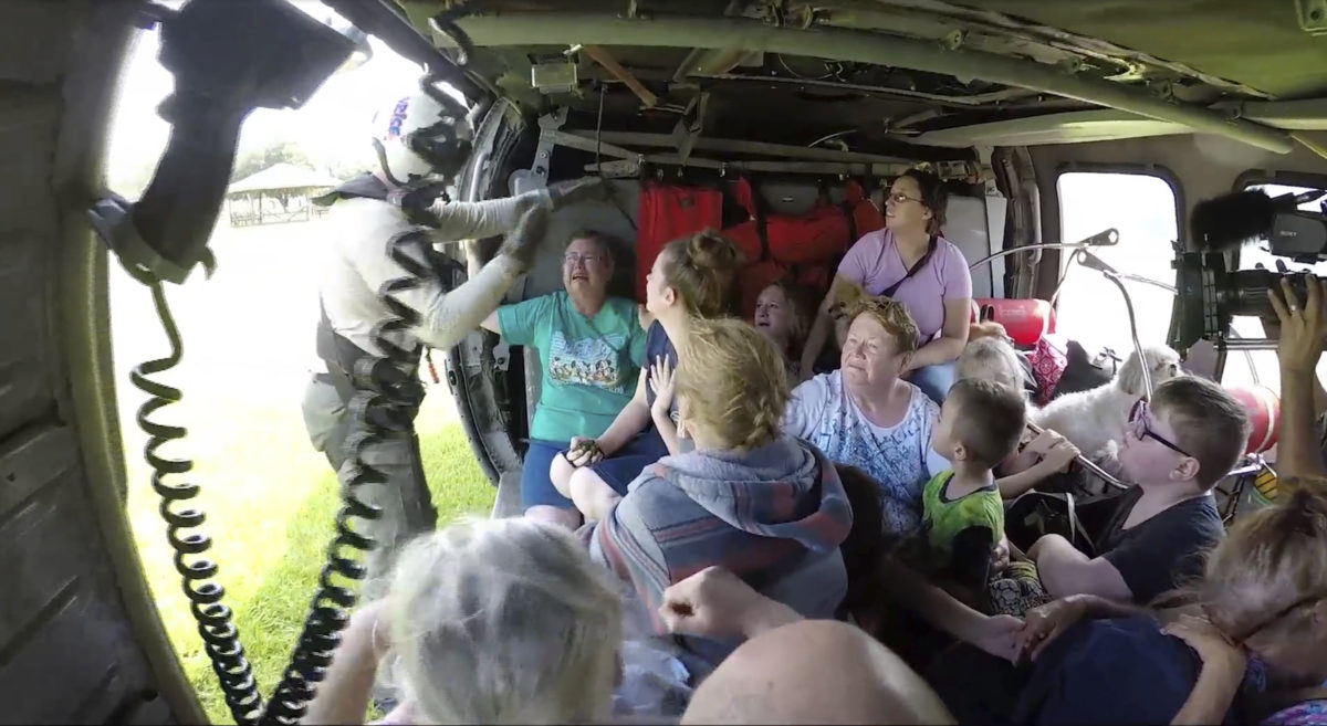 This still image taken from video provided by the U.S. Navy shows sailors from Helicopter Sea Combat Squadron (HSC) 28 rescuing 14 people and four dogs, at Pine Forrest Elementary School, in Vidor, Texas on Thursday, Aug. 31, 2017. The shelter that required evacuation after flood waters from Hurricane Harvey reached its grounds.