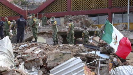 Soldiers remove debris from a partly collapsed municipal building, which was felled by a massive earthquake, in Juchitan, Oaxaca state, Mexico, on Friday.