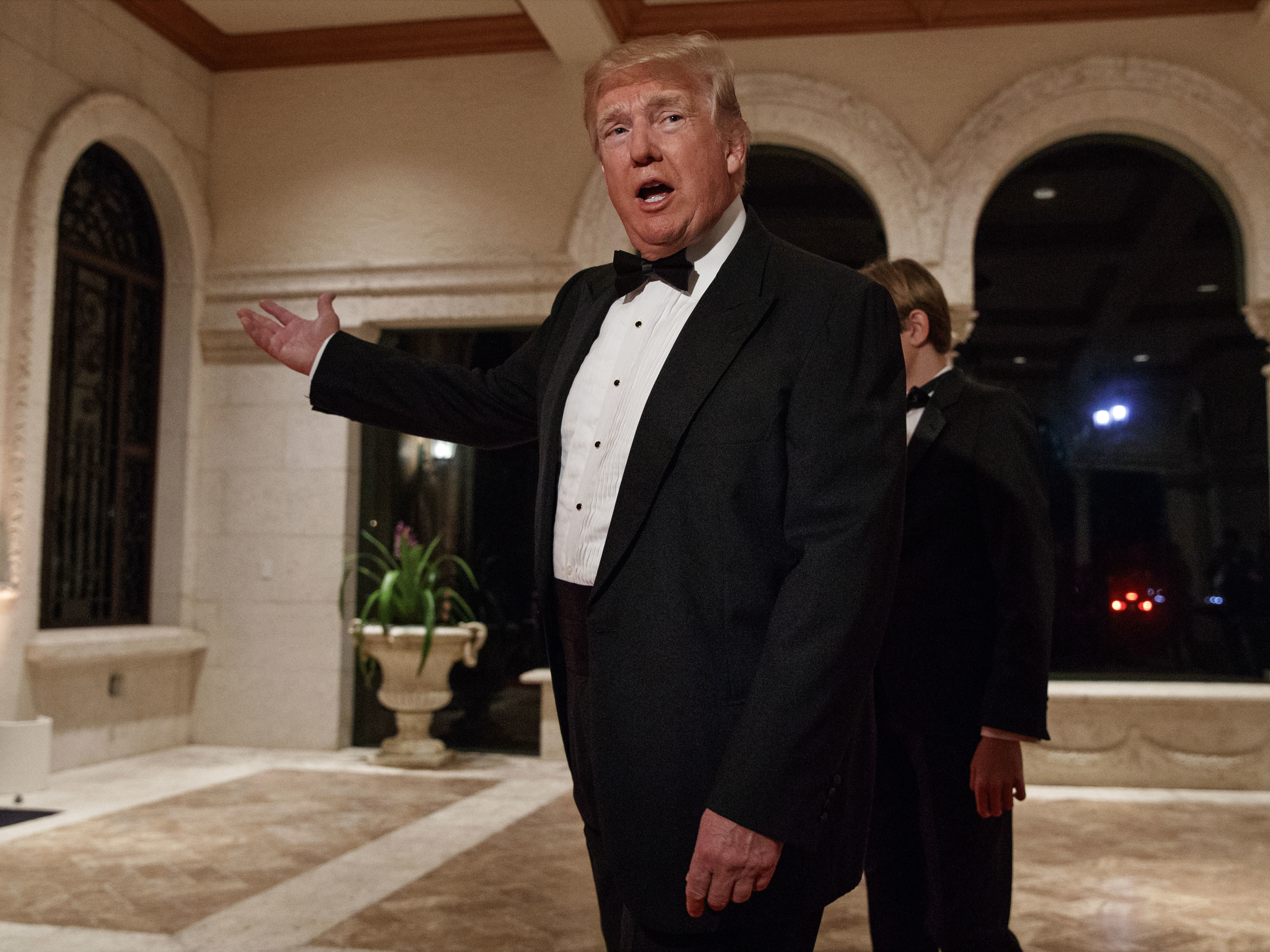 President Donald Trump speaks with reporters as he arrives for a New Year's Eve gala at his Mar-a-Lago resort, in Palm Beach, Fla., on Sunday.