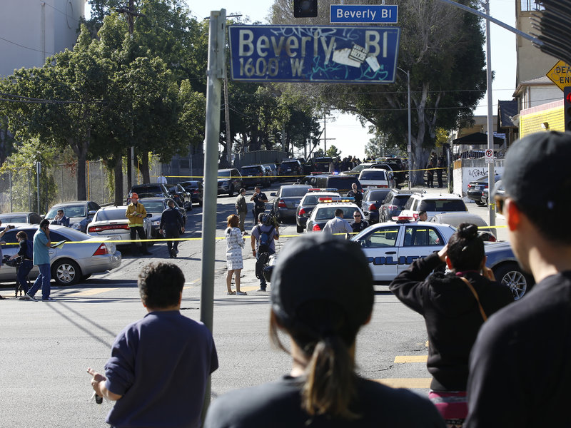 People wait for news about the shooting that left two injured at Salvador Castro Middle School in Los Angeles on Thursday.
