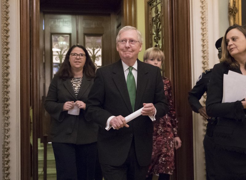 Senate Majority Leader Mitch McConnell, R-Ky., leaves the chamber after announcing an agreement in the Senate on a two-year, almost $400 billion budget deal that would provide Pentagon and domestic programs with huge spending increases, at the Capitol in Washington, Wednesday, Feb. 7, 2018. 