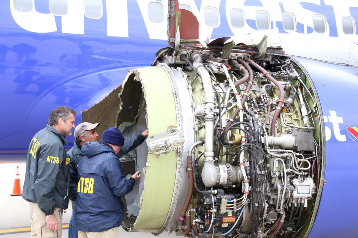 U.S. NTSB investigators are on scene examining damage to the engine of the Southwest Airlines plane in this image released from Philadelphia, Pennsylvania, U.S., April 17, 2018.    NTSB/Handout via REUTERS  ATTENTION EDITORS - THIS IMAGE HAS BEEN SUPPLIED BY A THIRD PARTY.     TPX IMAGES OF THE DAY - RC13FF7E9ED0