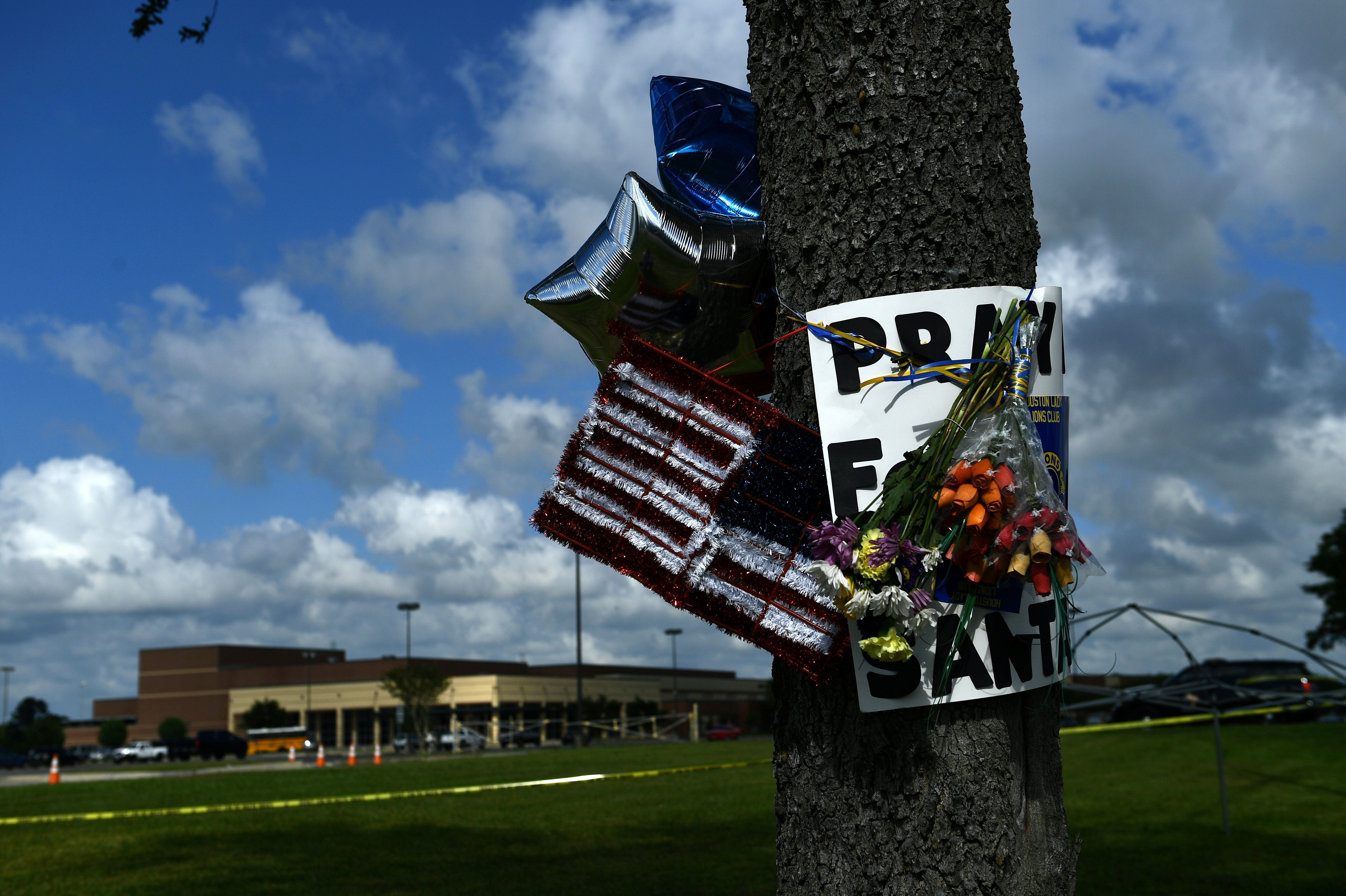 Memorial items hang on a tree near Santa Fe High School in Santa Fe, Texas, a day after eight students and two teachers were killed when a 17-year-old classmate allegedly opened fire at the school.
