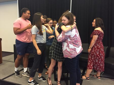 Madie Lake, an organizer with the Houston March for Our Lives group, hugs a student from Santa Fe High School at a press conference Friday.