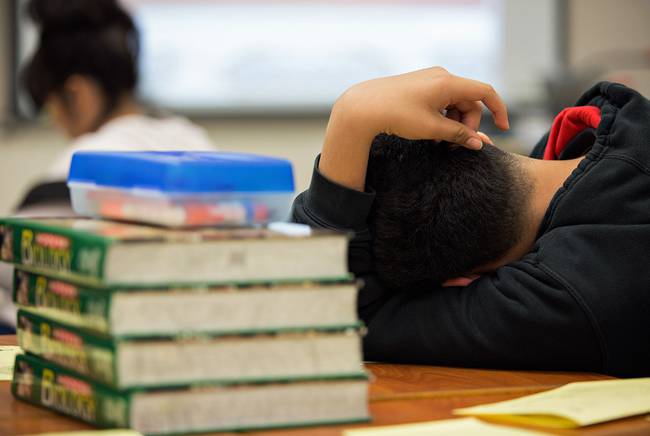 A student at the Elsik Ninth Grade Center rests during a lesson while participating in an after-school program.