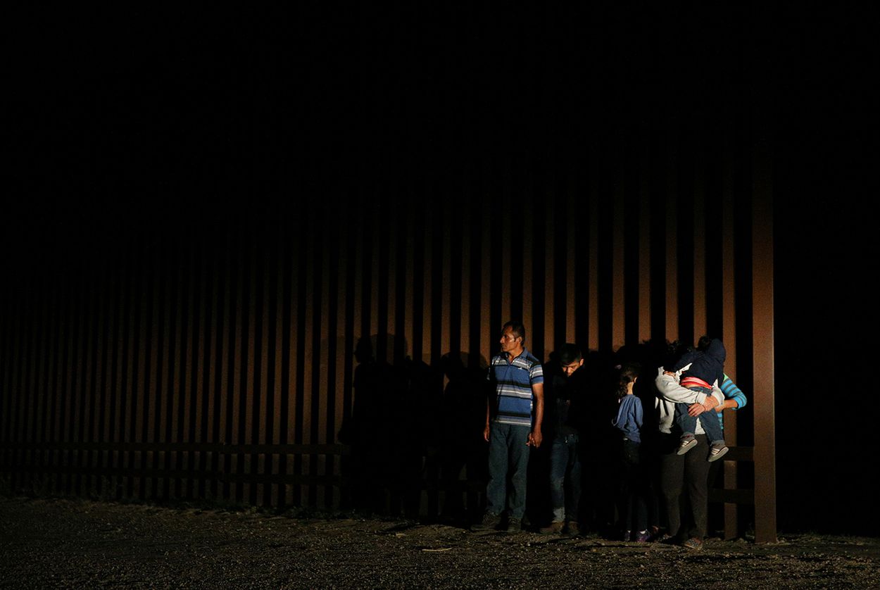 Immigrants who illegally crossed the Mexico-U.S. border are apprehended by the U.S. border patrol in the Rio Grande Valley sector, near McAllen, Texas, U.S., April 5, 2018. 