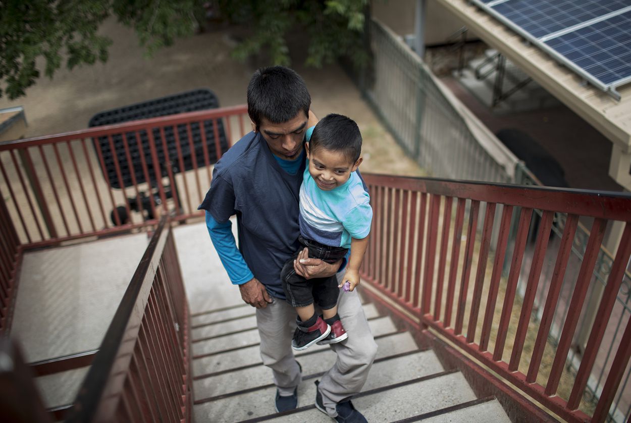 Pablo Ortiz and his son Andres of Guatemala walk upstairs at the Annunciation House in El Paso on July 11, 2018. Ortiz and his son were separated by ICE in April and were reunited and released the night before.  