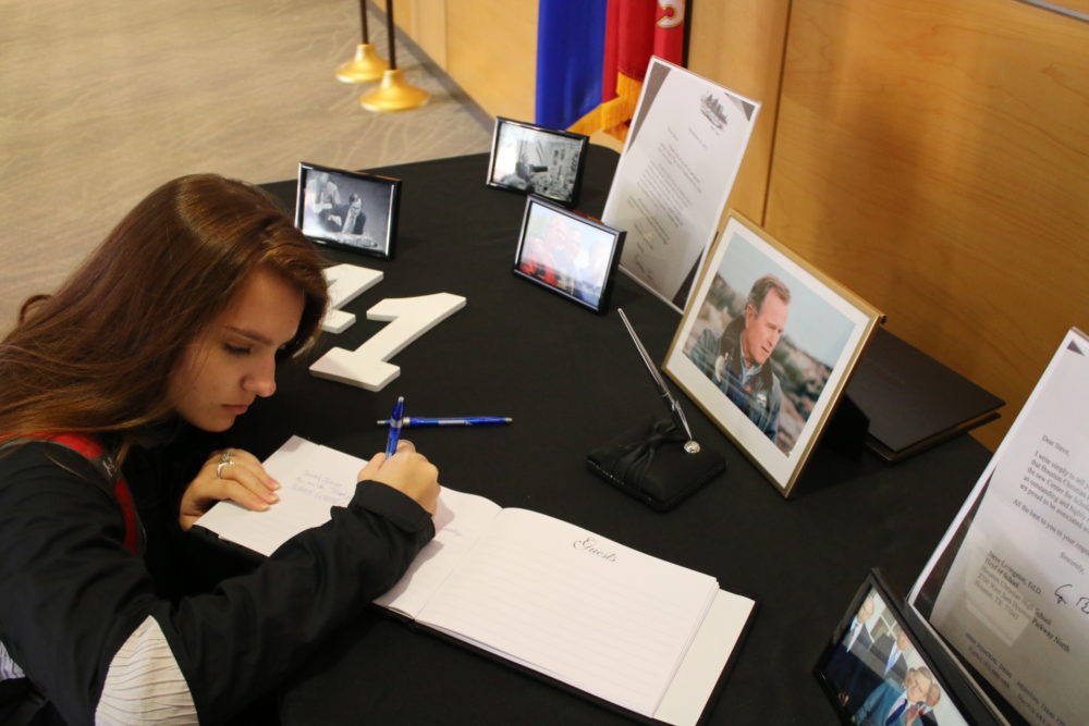 Senior Sydney Greene signs a book of condolences that will ultimately head to the Bush Presidential Library in College Station.