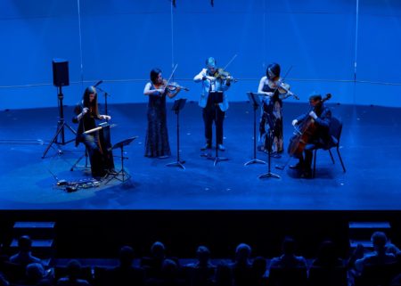 Photo of a string quartet and theremin player on stage