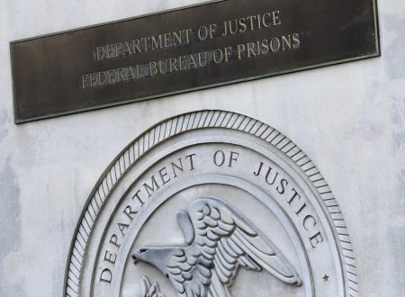 A sign for the Department of Justice Federal Bureau of Prisons.